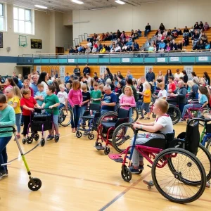 Participants engaging in wheelchair fittings and mobility aid demonstrations at Highland High School.